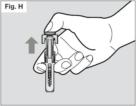 A hand gripping a cylindrical medical device pulling outward