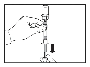 A hand holding the top part of a syringe while the
