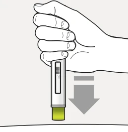A hand holding vertically a medical device for administration