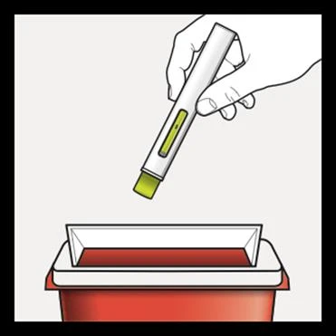 A hand holds a white medical device with yellow insert above a red rectangular container for medical waste disposal
