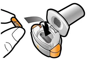 Hands removing a white and gray protective cap from a medical device with orange details on a white background