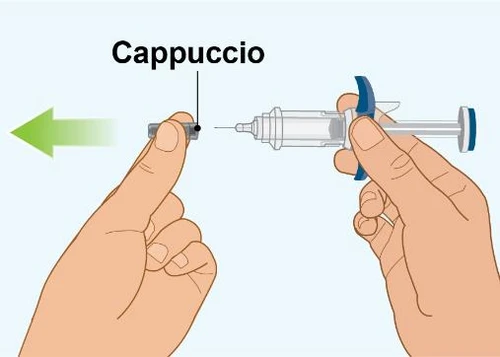Two hands holding a syringe while a green arrow indicates removal of the black cap from the