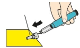 Una mano sostiene un dispositivo médico azul y gris para insertar una aguja en una superficie amarilla siguiendo la dirección de una flecha negra