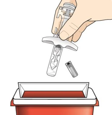 A hand holding a transparent injection pen above a red sharps disposal container for used needles and medical devices