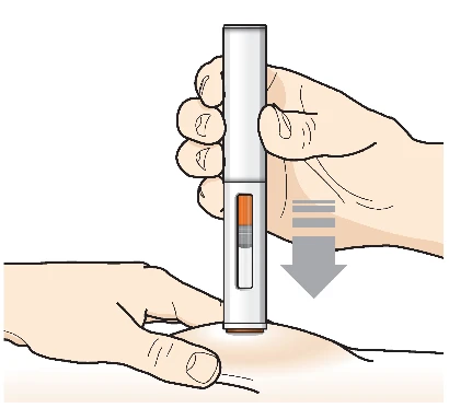 A hand holding an injection pen vertically while the