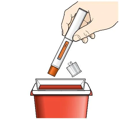 A hand holding a white injection pen with orange details above an open red biological waste container