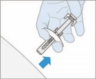 A gloved hand holding a pre-filled syringe and pushing it downward in the direction indicated by a blue arrow