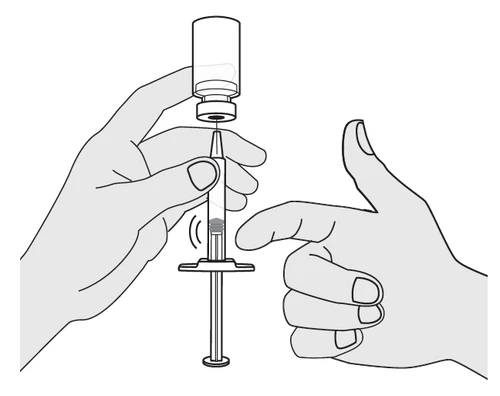 Two hands preparing a syringe with needle inserted into a glass vial to draw up the contents with the plunger facing downward