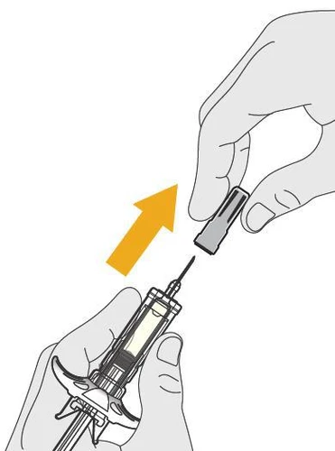 A hand lifting a gray cap off the needle of a syringe containing liquid inside