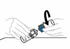 Two hands rotating a blue cap on a white cylindrical medical device to attach or remove it, with a black curved arrow