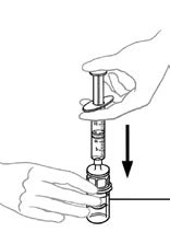 A hand pressing the plunger of a syringe downward to draw liquid from a vial held with the