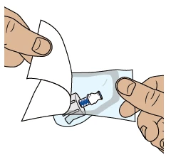 Dos manos abren un envase de plástico transparente para extraer un dispositivo médico con capuchón azul y base blanca