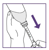A hand holding the top part of a medical device while the