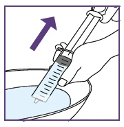 A hand holding a syringe with liquid