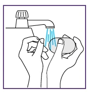 Two hands washing a bar of soap under a water stream