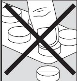 Black and white drawing of a hand removing a tablet from a blister pack with a large black cross over it indicating prohibition