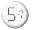 White circular tablet with the numbers 5 and 7 engraved on the upper surface separated by a central dot
