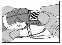 Two hands holding and adjusting a drug dispenser, sliding a finger along the device's measurement scale to precisely set the dose