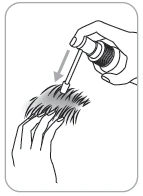 A hand holding an applicator with liquid being directed toward the hair on another person's head, indicated by a directional arrow