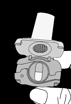 A hand holding an open medical device with a visible medication capsule placed inside the mechanism in gray and white colors