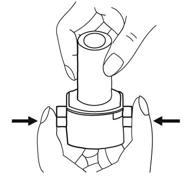 Two hands holding a medical device, one hand gripping the upper part and the other hand squeezing the sides of the casing as indicated by black arrows