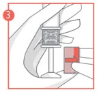 A hand holding a syringe vertically while a second hand pushes the plunger down, indicating a medication administration or dose preparation process