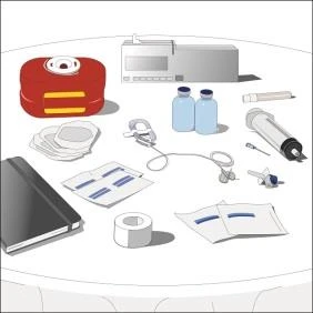 A medical set on a white table contains a syringe, vials, tape, gauze pads, documents, a notepad, a red container, and a measuring device