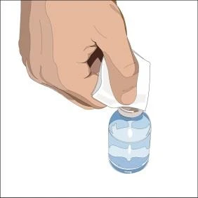 A human hand holding a piece of white gauze and wiping a glass vial containing a transparent liquid to disinfect it prior to use