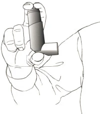 A hand holding an inhaler in upright position, ready to administer medication, against the background of a piece of the user's clothing