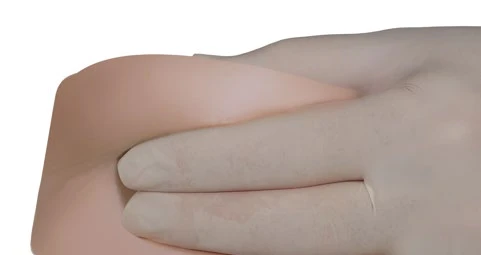 Primer plano de una mano con guante médico blanco presionando suavemente y masajeando la piel del abdomen para la aplicación de un medicamento o examen