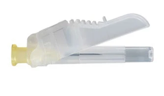 A transparent housing of a medical device with an open, toothed dome revealing the internal mechanism and a glass vial containing medication