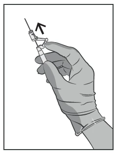 A gloved hand holds a syringe, pulling the plunger upward, indicating the fluid aspiration process through the needle