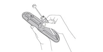 Two hands holding a long, pen-like injector with a visible needle and plunger, prepared for drug administration, shown in a medical instruction for use