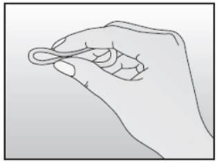 Right hand holding a small, round object resembling a ring or thin rubber band horizontally against a bright background
