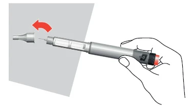Hand holding an injector with a red tip, removing the needle shield indicated by a red arrow pointing to the left