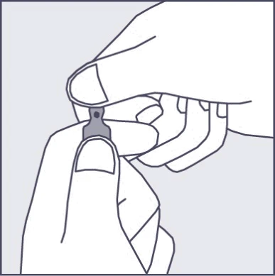 Two hands holding and separating a small, gray component of a medical package, preparing it for use or opening