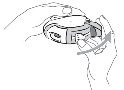 Two hands holding a white medical device, with a curved arrow indicating clockwise rotation of a component