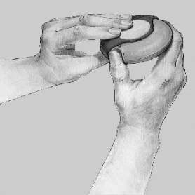 Two hands holding and opening a round, two-part medical device with a visible central depression on a gray background
