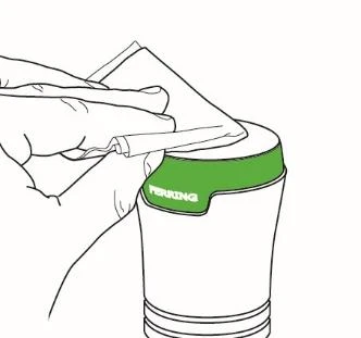 Hand holding a white paper pouch and carefully pouring its contents into a white container with a green stripe labeled PERRING