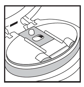 Dibujo esquemático de un dispositivo médico abierto que muestra el mecanismo interno y una superficie plana dentro de una carcasa circular