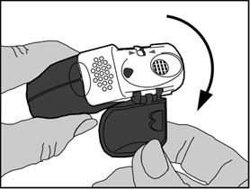 Hands holding a medical device, one finger pressing a button while the other rotates part of the device clockwise