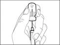 Hand holding an auto-injector pen with needle, prepared for injection