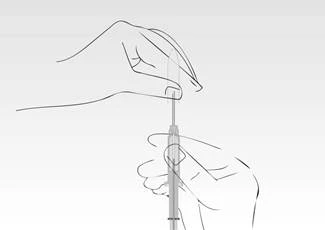 A hand holds a syringe while another hand presses the plunger, injecting fluid through the needle, indicating the injection process or its preparation