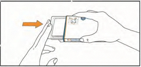 A hand pressing the button on the injection device