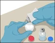 Hands in blue gloves opening a medication vial, wiping the stopper with a wipe, with red and blue caps from vials nearby