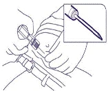 A hand holding a syringe at a 45-degree angle, inserting the needle into the muscle tissue of the arm, close-up view of the needle shown in a separate window